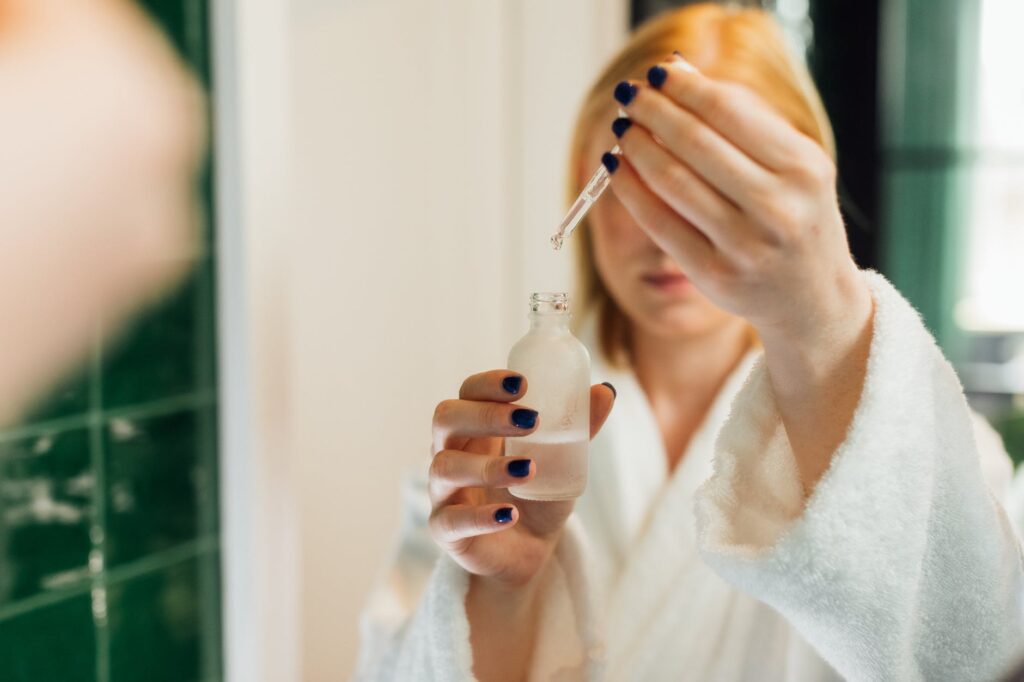 Chic Style Collective | Fruit Enzyme Skincare, What is it and should you be using it? Fruit Enzyme skincare
reflection of a woman holding a bottle of serum